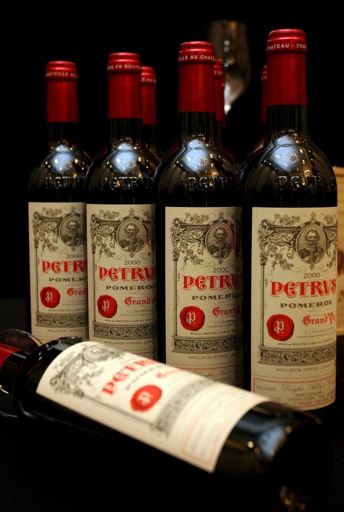 epa01548359 Bottles of 2000 Chateau Petrus are on display for the Acker Merrall & Condit Fine Rare Wine Auction at a press conference in Hong Kong, China 12 November 2008. A case of 12 bottles of 2000 Chateau Petrus will sell at a auction on 15 November in Hong Kong, and is expected to fetch between HK$320,000 to HK$400,000 (32,000 euro to 40,000 euro).  EPA/YM YIK