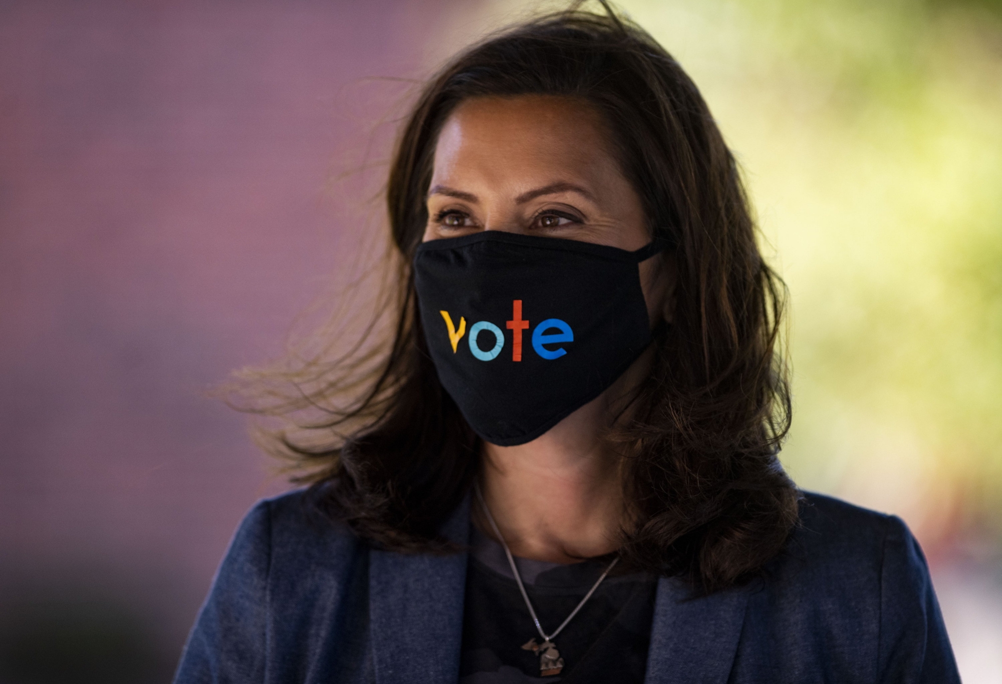 Michigan Gov. Gretchen Whitmer wears a mask with the word "vote" displayed on the front during a roundtable discussion on healthcare, Wednesday Oct. 7, 2020, in Kalamazoo, Mich. The arrest of a group of anti-government vigilantes in a kidnapping plot against Michigan Gov. Gretchen Whitmer presents a new twist in the 2020 political fight for the battleground state. (Nicole Hester/Ann Arbor News via AP)/ ArcInfo