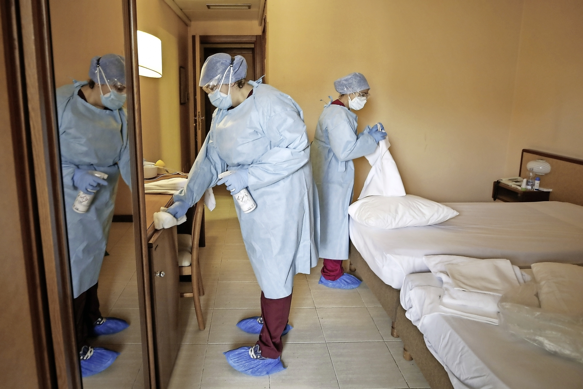 A room of a hotel gets cleaned to welcome patients recovering from COVID-19 who need to undergo quarantine, under the supervision of the Gemelli hospital, in Rome, Saturday, Nov. 14, 2020. (Cecilia Fabiano/LaPresse via AP)