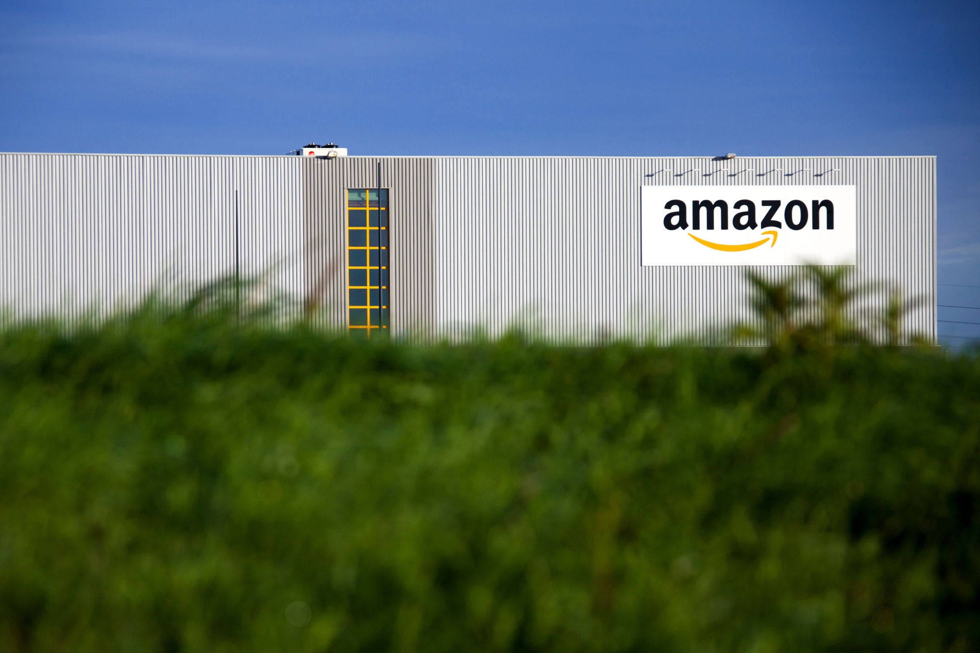 This Sept.19, 2013 photo shows the logistics center of online merchant Amazon in Lauwin-Planque, northern France. The Organization for Economic Cooperation and Development released a plan Monday, Oct.5, 2015 to end tax shelters and require companies to pay taxes in the countries where they earn profits, among other measures. Google, Facebook, Starbucks and Amazon are among many companies criticized for shifting profits to low-tax jurisdictions. (AP Photo/Michel Spingler)