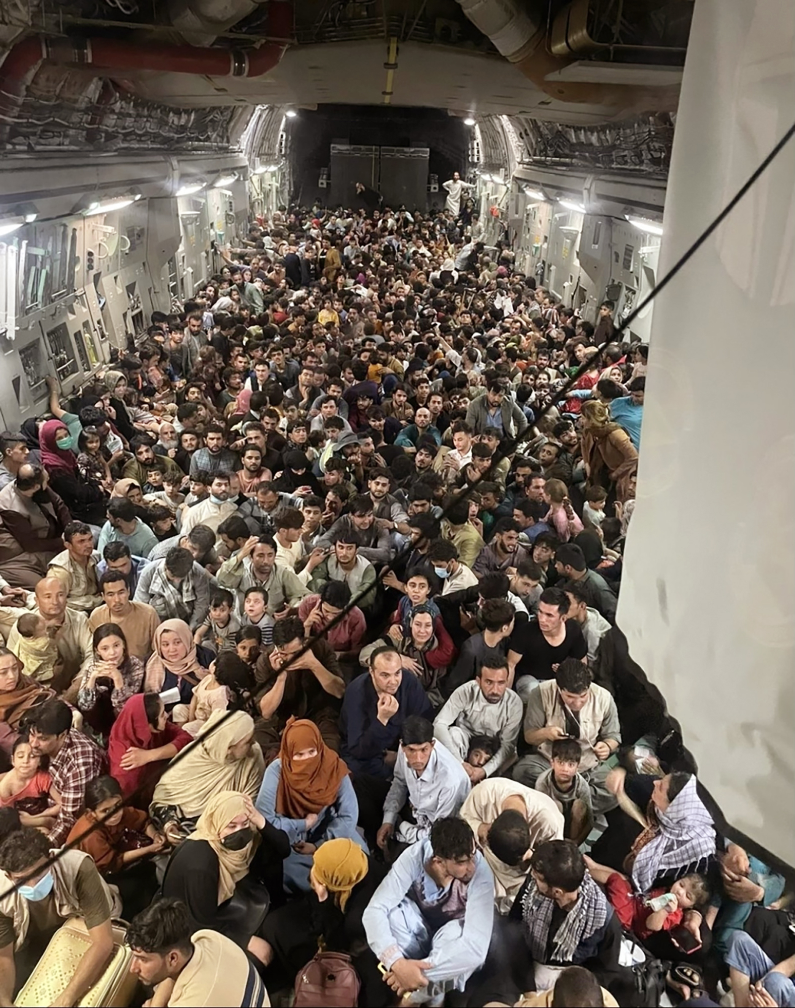 Afghan citizens pack inside a U.S. Air Force C-17 Globemaster III, as they are transported from from Hamid Karzai International Airport in Afghanistan, Sunday, Aug. 15, 2021. The Taliban on Sunday swept into Kabul, the Afghan capital, after capturing most of Afghanistan. (Capt. Chris Herbert/U.S. Air Force via AP)