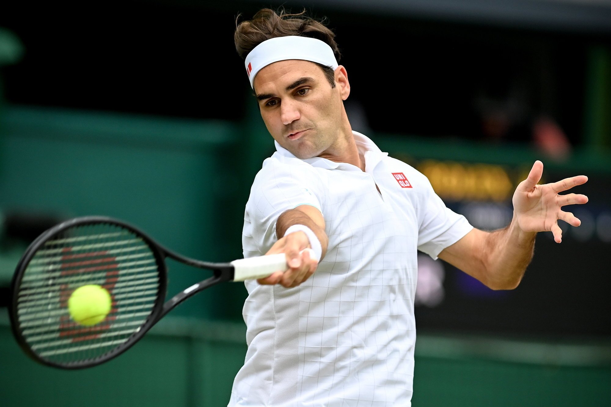 epa09329002 Roger Federer of Switzerland hits a forehand during the men's quarter final match against Hubert Hurkacz of Poland at the Wimbledon Championships, in Wimbledon, Britain, 07 July 2021.  EPA/NEIL HALL   EDITORIAL USE ONLY