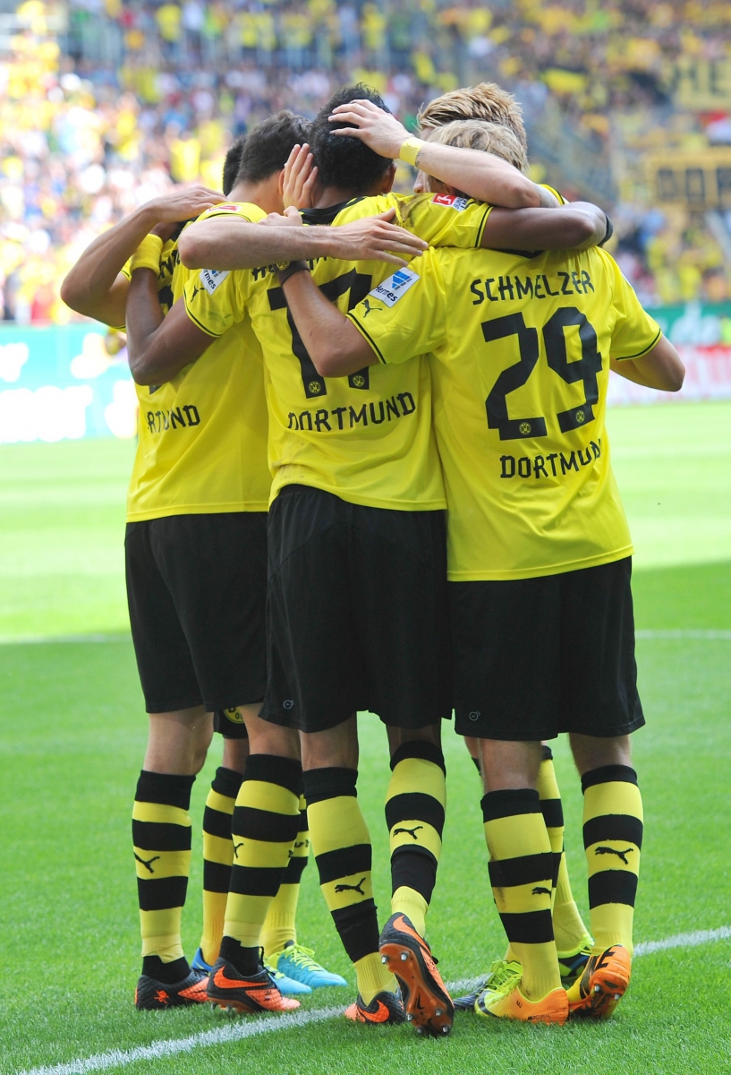 Dortmund's players celebrate after scoring during the German first division Bundesliga soccer match between FC Augsburg and Borussia Dortmund in Augsburg, Germany, Saturday, Aug. 10, 2013. (AP Photo/Kerstin Joensson)