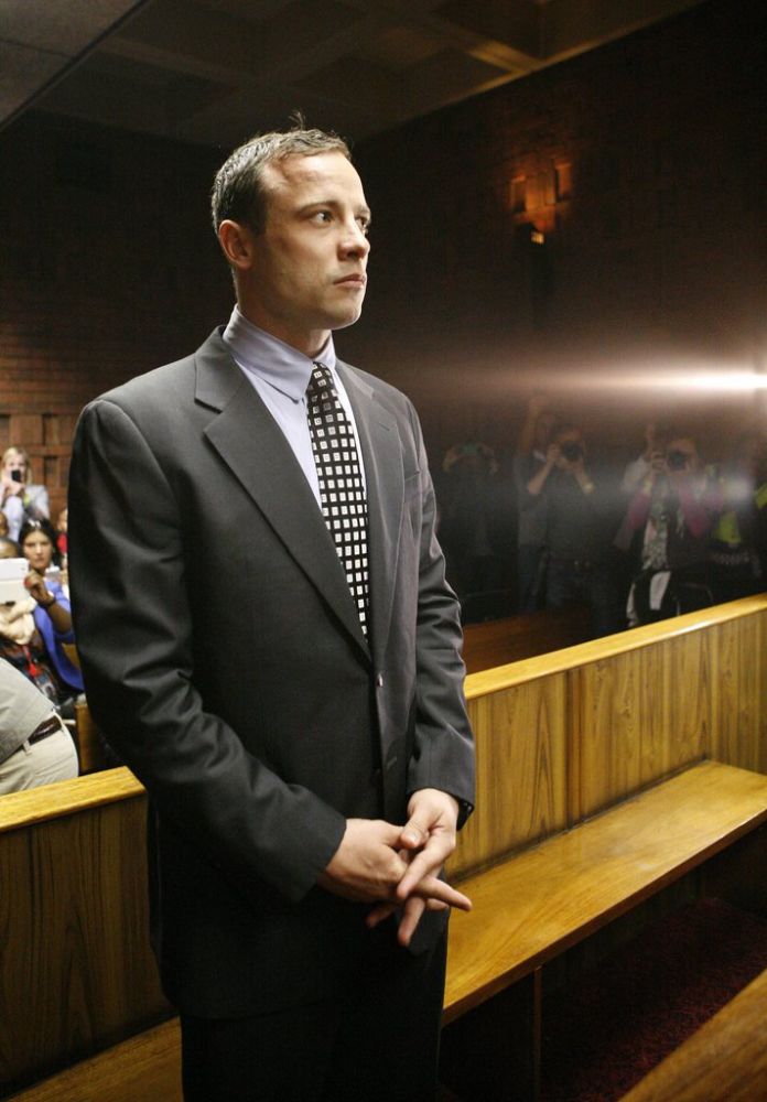Oscar Pistorius appears in the magistrates court in Pretoria, South Africa, Tuesday, June 4, 2013. Pistorius is back in the glare of public scrutiny for the first time in months, launching the next chapter of a sensational case that transformed the double-amputee Olympian from a smiling global inspiration to a sobbing suspect facing a life sentence in prison if convicted of killing his girlfriend. (AP Photo/Themba Hadebe)