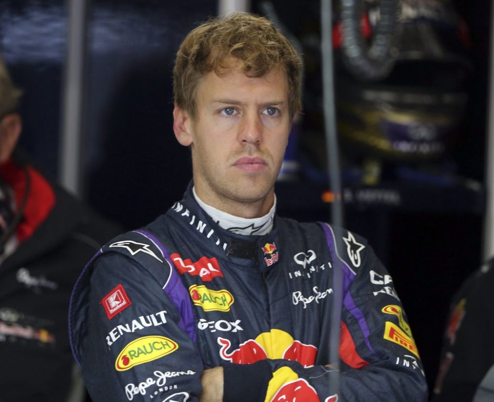 Red Bull driver Sebastian Vettel of Germany watches in the pits during the first free practice at the Nuerburgring racetrack, in Nuerburg, Germany, Friday, July 5, 2013. Formula One drivers threatened to withdraw from the German Grand Prix if there are more tire blowouts during Sunday's race. Last weekend, a number of blowouts overshadowed the British GP, causing tire supplier Pirelli to introduce a new plan to stop the same thing from happening again. But the Grand Prix Drivers' Association said Thursday in a statement that the drivers would pull out if the problem persists.The Formula one race will be held on Sunday. (AP Photo/Luca Bruno)