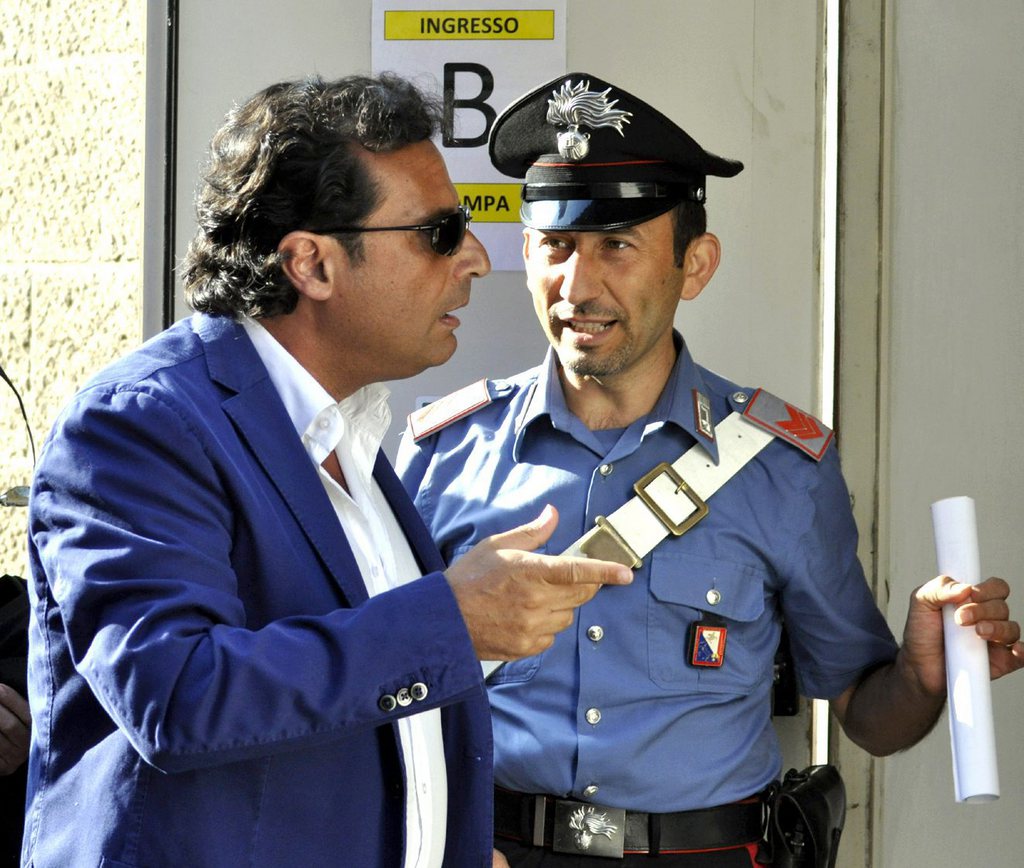Captian Francesco Schettino arrives for his trial, in Grosseto, Italy, Tuesday, July 9, 2013. The trial of the captain of the shipwrecked Costa Concordia cruise liner has begun in a theater converted into a courtroom in Tuscany to accommodate all the survivors and relatives of the 32 victims who want to see justice carried out in the 2012 tragedy. The sole defendant, Schettino, made no comment to reporters as he arrived for his trial on charges of multiple manslaughter, abandoning ship and causing the shipwreck near the island of Giglio. His lawyer, Domenico Pepe, told reporters that, as expected, the judge was postponing the hearing though due to an eight-day nationwide lawyers' strike. Schettino has denied wrongdoing. (AP Photo/Giacomo Aprili)