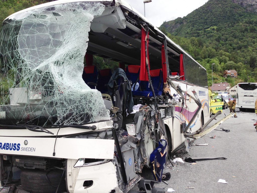 The wreckage of a tour bus in which two people have been confirmed killed in a collision between a Swedish tourist bus and a Norwegian bus in Fardal, Norway Monday Aug. 12, 2013. (AP Photo/NTB Scanpix, Christian Blom)  NORWAY OUT