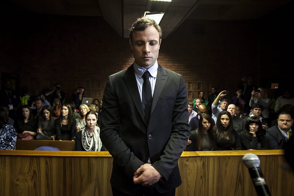 epa03830502 Murder accused Oscar Pistorius (C) appears in the Pretoria Magistrates court in Pretoria, South Africa, 19 August 2013. The trial of double-amputee Olympic sprinter Oscar Pistorius, accused of the premeditated murder of his girlfriend Reeva Steenkamp, will begin on 03 March 2014, a judge ruled on 19 August 2013. Judge Desmond Nair set the trial to run through March 20 next year at a high court in Pretoria, in coordination with defence lawyers and the prosecution.  EPA/STR