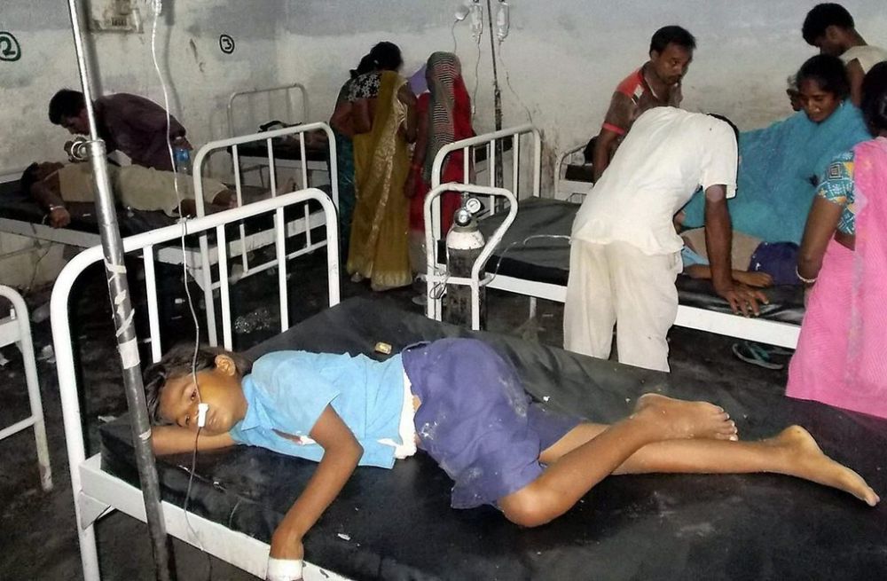 In this Tuesday, July 16, 2013 photo, schoolchildren receive treatment at a hospital after falling ill soon after eating a free meal at a primary school in Chhapra district, in the eastern Indian state of Bihar. At least 20 children have died and more are sick after eating free meals in the school, an official said Wednesday. The children are age 8 to 11. (AP Photo)