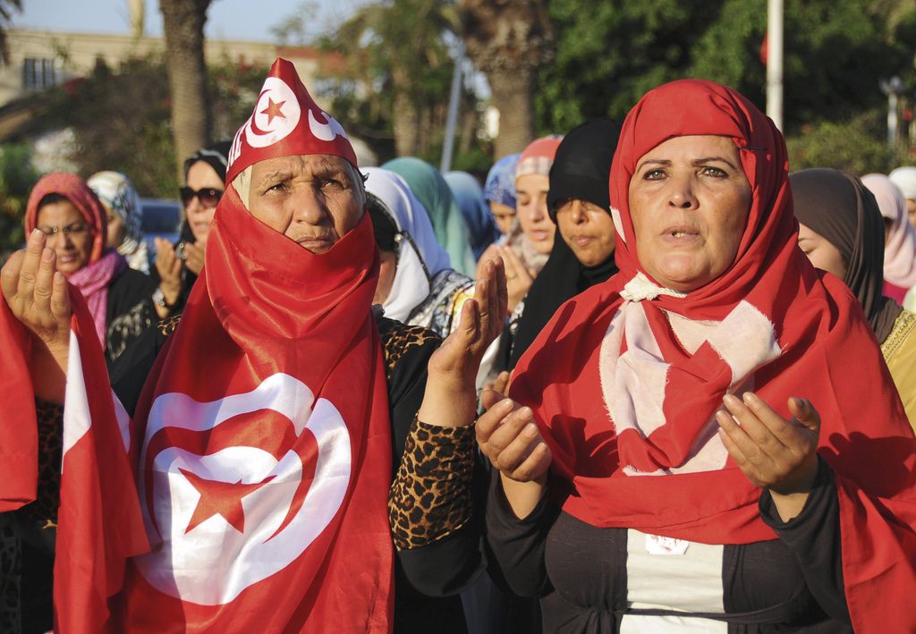 Protesters gather on the main avenue of Tunis after the leader of a leftist Tunisian opposition party, Mohammed Brahmi, was gunned down as he left home, in Tunisia, Thursday, July 25, 2013.  Brahmi, 58, of an Arab nationalist political party was in his car outside home when gunmen fired several shots at him, said Interior Ministry spokesman Mohammed Ali Aroui. It is the second killing of an opposition member this year, following that of Chokri Belaid, a member of the same leftist Popular Front coalition as Brahmi. Belaid was also shot dead in his car outside his home in February. His killing provoked a political crisis that nearly derailed Tunisia's political transition. (AP Photo/Hassene Dridi)