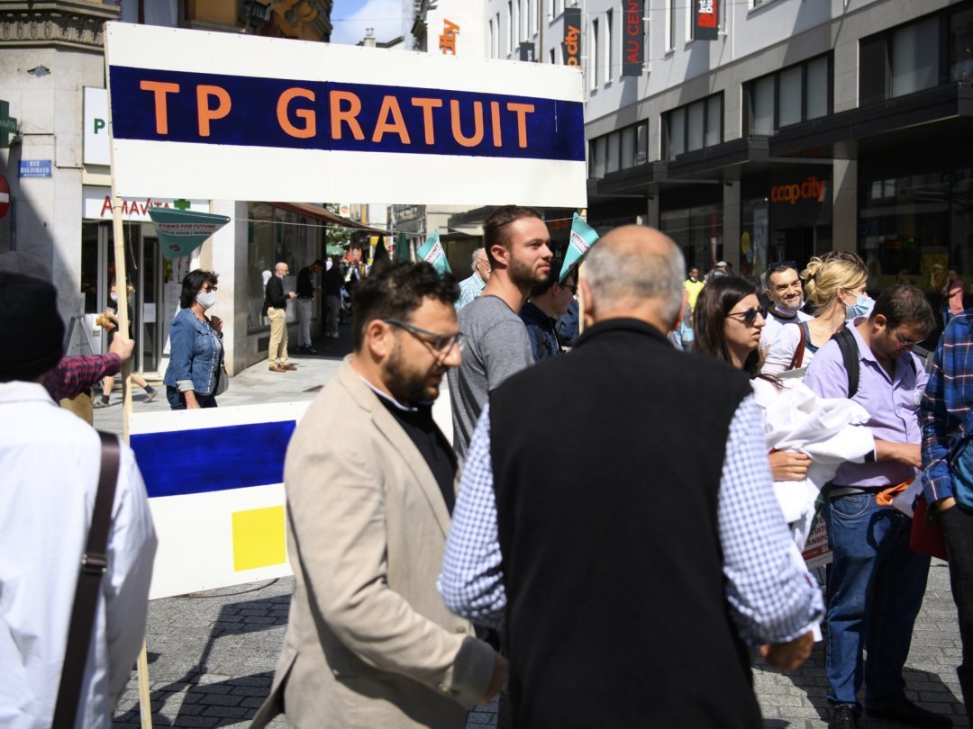 Des personnes manifestent pour le bus gratuit lors du lancement officiel de la récolte des signatures de l' initiative vaudoise pour des transports publics gratuits, mardi 24 aout 2021 a Lausanne.