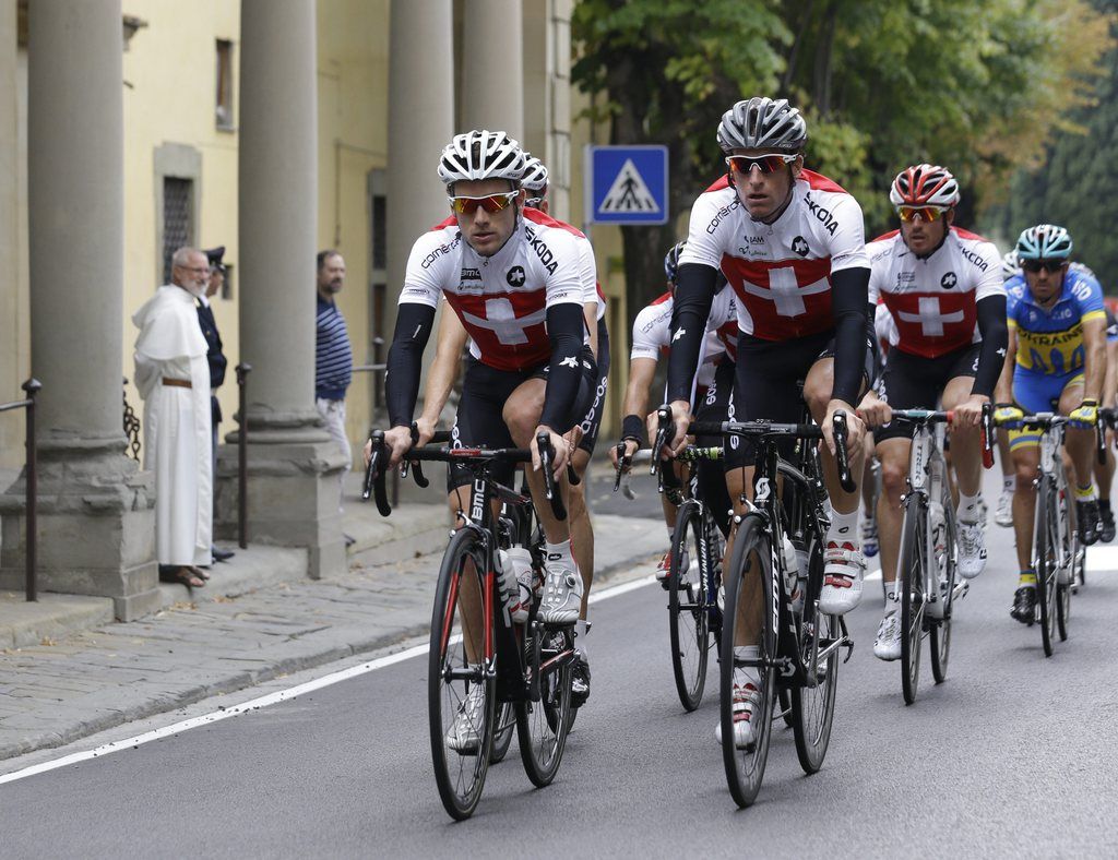 Swiss cyclist Martin Elmiger, front right, passes by the church of St. Domenico as he trains flanked by unidentified teammates during a no-race day at the road cycling world championships in Fiesole, near Florence, Italy, Thursday, Sept. 26, 2013. The worlds conclude on Sunday with the featured road race over a 272-kilometer (169-mile) route that starts in Lucca near the coast and ends with 10 laps of a hilly circuit in and around Florence. (AP Photo/Luca Bruno)