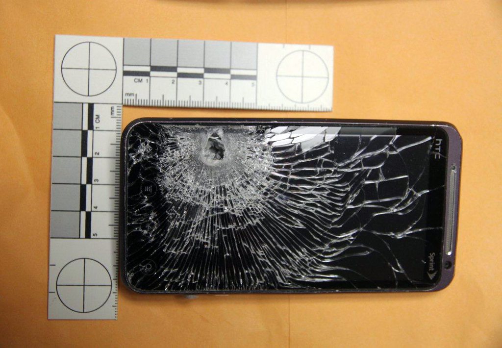 This Monday, Oct. 28, 2013 photo photo provided by the Winter Garden Police Department shows the front of the cellphone belonging to a Winter Garden, Fla. Hess gas station clerk that stopped a bullet fired at him during an early morning robbery. Police say the clerk sustained only minor injuries after the robber fired a bullet at the man's abdomen that was stopped by the cellphone. (AP Photo/Winter Garden Police)