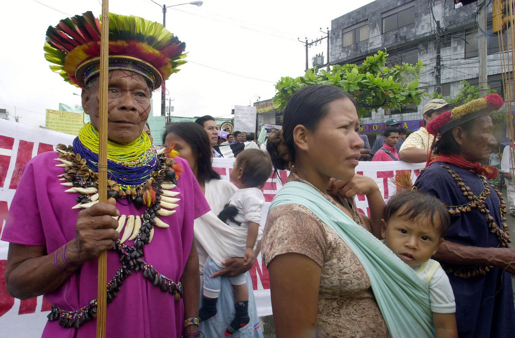 Members of the indigenous Secoya communitiy march down a  streets to a court where demonstrators hold a protest against Chevron-Texaco in Lago Agrio 180 kms (110 miles) northeast of Quito, Ecuador on Tuesday, Oct. 21, 2003. Texaco is accused of alledged ecological damages in Ecuador's Amazon region during two decades of petrolium extraction. (AP Photo/Dolores Ochoa)(AP Photo/Dolores Ochoa)