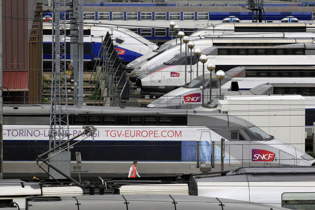 TGV high speed trains are parked near Gare de Lyon station in Paris, Thursday June 13, 2013, as French rail workers strike to protest a reorganization of the national rail and train companies. Up to 70 percent of train journeys in France will be canceled on Thursday. The action began Wednesday night, affecting overnight, international travel and ends Friday morning. (AP Photo/Remy de la Mauviniere)