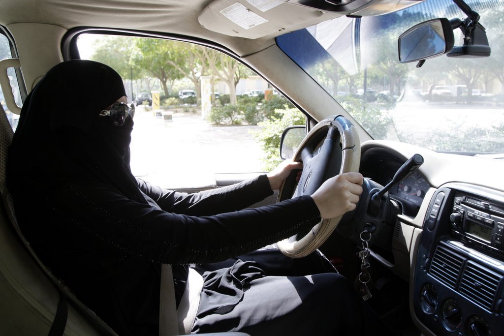 epa03928059 A Saudi woman sits behind the wheel of a car in Riyadh, Saudi Arabia, 28 October 2013. Media reports on 27 October state that Saudi authorities arrested 14 women for driving in the conservative kingdom. The women were detained in the capital Riyadh, the western cities of Jeddah and Mecca as well as the Eastern Province. Activists have published more than a dozen videos on YouTube showing women driving in defiance of the decades-long "ban," which makes the oil-producing kingdom the world's only country where women are not allowed to drive.  EPA/STR
