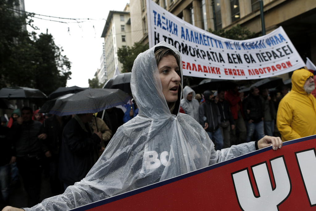 Members of pro-communist union PAME take part in an protest during a general strike in Athens, on Wednesday, Nov. 6, 2013. Services across Greece shut down Wednesday as unions held a 24-hour general strike to protest further austerity cuts in the cash-strapped country. (AP Photo/Petros Giannakouris)