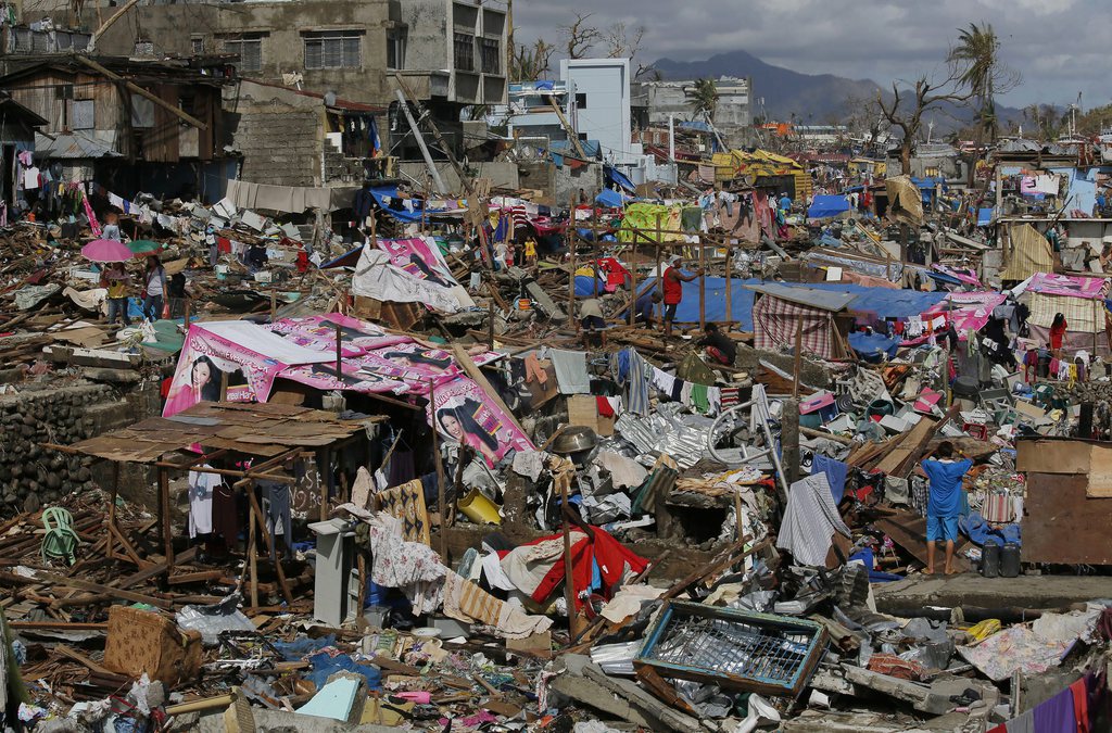 Survivors rebuild their house in typhoon ravaged Tacloban city, Leyte province, central Philippines on Wednesday, Nov. 13, 2013. Typhoon Haiyan, one of the strongest storms on record, slammed into central Philippine provinces Friday, leaving a wide swath of destruction and thousands of people dead. (AP Photo/Vincent Yu)