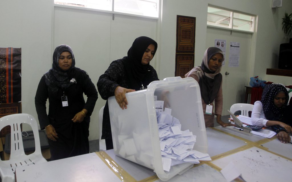 An elections official empties out a ballot box to count votes in Male, Maldives, Saturday, Nov. 16, 2013. Voters in the Maldives cast their ballots Saturday in a presidential runoff that was held amid international concerns that the tiny archipelago nation may slip back to strongman rule after long delays in the election. (AP Photo/Sinan Hussain)