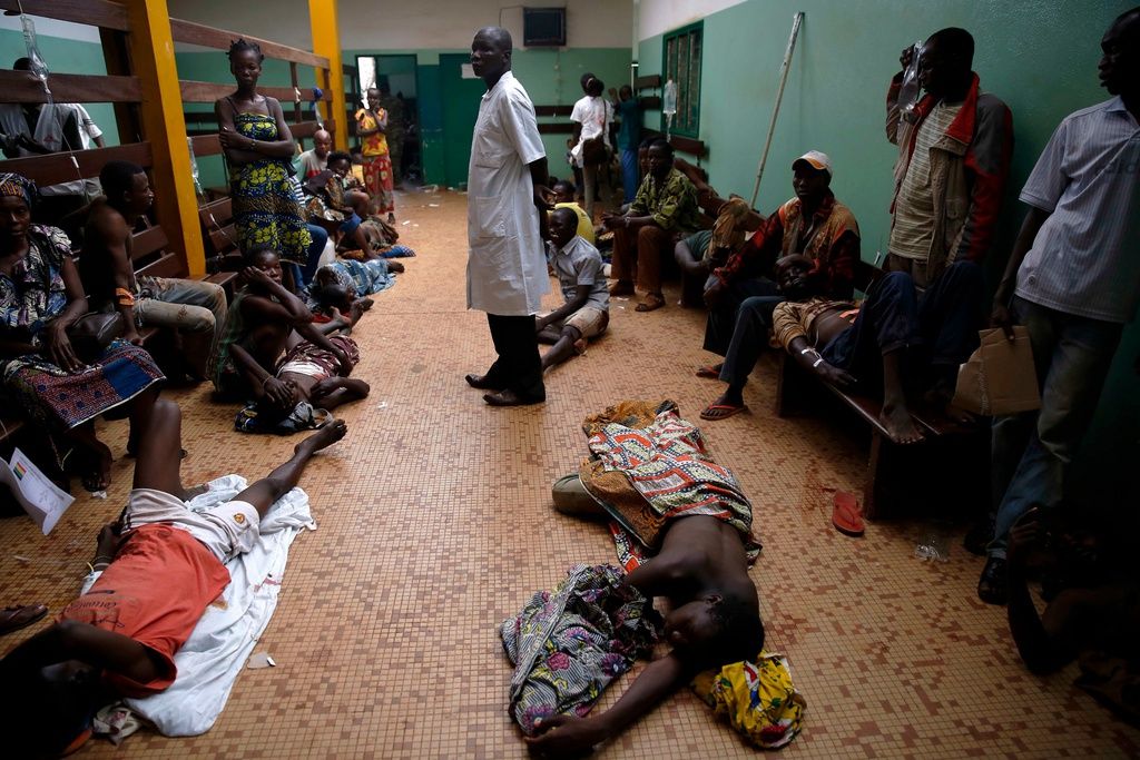 Wounded civilians lie on the floor of Bangui's hospital, Bangui, Central African Republic, Thursday Dec. 5, 2013 waiting for treatment following a day-long gun battle between Seleka soldiers and Christian militias. Fighting came to the capital of Central African Republic on Thursday, leaving dozens of casualties and posing the biggest threat yet to the new government just as the U.N. Security Council authorized an intervention force to prevent a bloodbath between Christians and Muslims. (AP Photo/Jerome Delay)