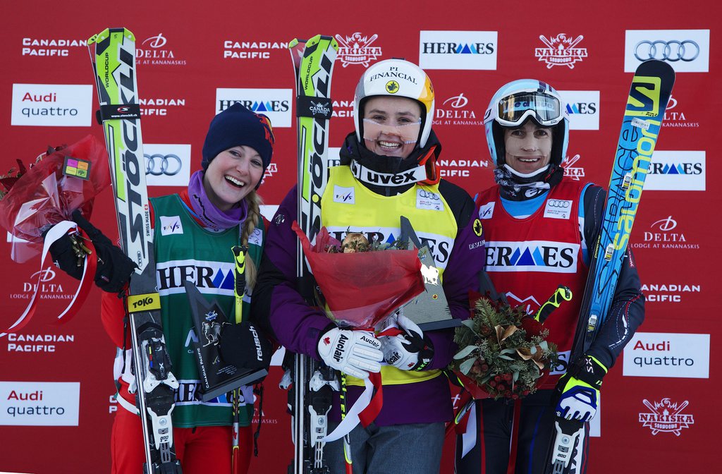 Marielle Thompson, center, of Canada celebrates her first place finish on podium with Fanny Smith, left, of Switzerland, who finished second and Ophelie David, of France, who finished third in the women's World Cup ski cross event in Nakiska, Alberta, Saturday, Dec. 7, 2013. (AP Photo/The Canadian Press, Todd Korol)