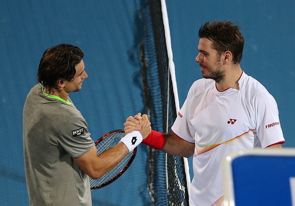 epa04001514 Spain's David Ferrer shakes hand with Switzerland's Stanislas Wawrinka after their match at the first day of Mubadala World Tennis Championship in Abu Dhabi, United Arab Emirates, 26 December 2013.  EPA/ALI HAIDER