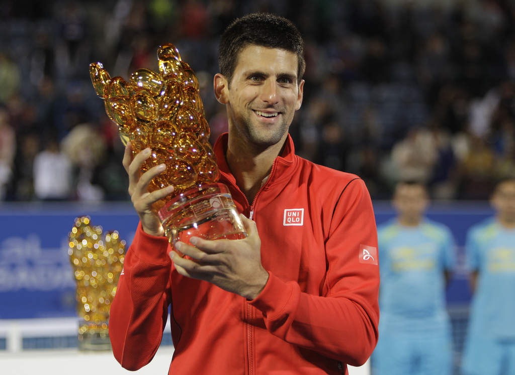 Novak Djokovic of Serbia holds the trophy after he beat David Ferrer of Spain during the final match of the Mubadala World Tennis Championship in Abu Dhabi, United Arab Emirates, Saturday, Dec. 28, 2013. (AP Photo/Kamran Jebreili)