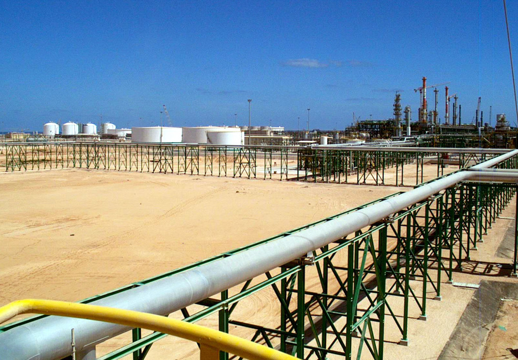 An undated but recent handout picture showing the new Eni (The Italian oil and gas company) gas compression plant settled on the shore of Mellitah, Libya. The Mellitah plant is part of a new gas pipleine which will connect Libya to the Italian island of Sicily and will be inaugurated by Libyan leader Moammar Ghadafi and Italian Premier Silvio Berlusconi, Thursday, Oct. 7, 2004. (KEYSTONE/AP Photo/Eni Press office)   ==  ===