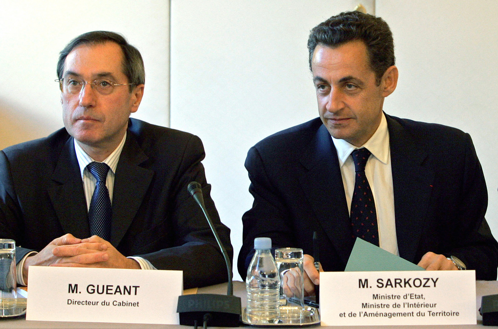 French Interior Minister Nicolas Sarkozy, right, and his top aide Claude Gueant attend a meeting with the prefects of the seven zones subjected to a curfew, Tuesday, Nov. 8, 2005 at the interior ministry in Paris. President Jacques Chirac declared a state of emergency Tuesday to impose curfews on France's riot-hit cities and towns, an extraordinary measure to halt the country's worst civil unrest in decades after violence raged for a 12th night. (AP Photo/Jack Guez/Pool)