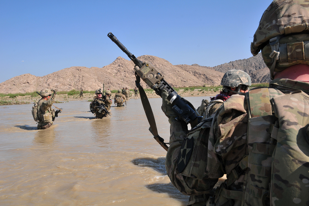 In this April 10, 2013 photo released by the U.S. Army, U.S. Soldiers with Charlie Company, 1st Battalion, 38th Infantry Regiment, 4th Brigade Combat Team, 2nd Infantry Division cross the Tarnak river in the Panjwai district of Kandahar province, Afghanistan on a two-day mission to clear the area of explosives caches. The Taliban have announced they will launch their spring offensive on Sunday, April 28, 2013, signaling plans to step up attacks as the weather warms across Afghanistan, making both travel and fighting easier.  (AP Photo/Sgt. Kimberly Hackbarth, U.S. Army)