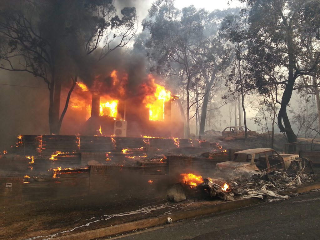 epa03914119 A house is engulfed in flames from bushfires in Yellow Rock, Blue Mountains, near Sydney, Australia, 17 October 2013. Media reports state that hundreds of houses may have been lost to forest fires in Australia's south-east, citing officials on 17 October. Crews battled to save homes without the help of fire-fighting aircraft, which were grounded because high winds and low visibility made flying too risky.  EPA/JASON WEBSTER AUSTRALIA AND NEW ZEALAND OUT