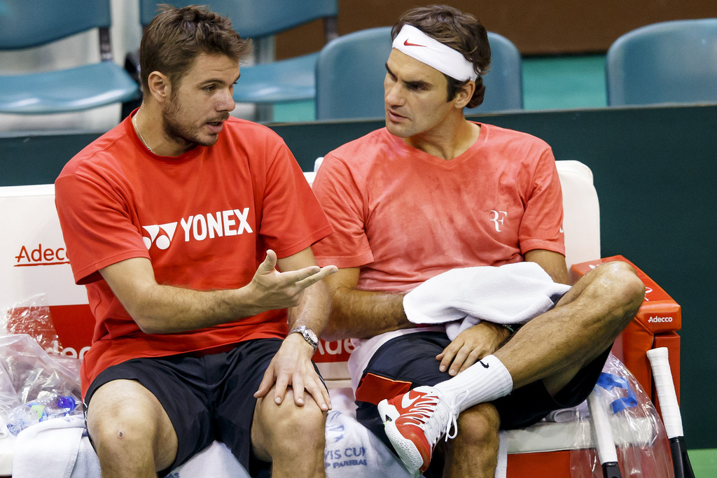 Stanislas Wawrinka, left, of Switzerland, speaks with Roger Federer, right, during a training session, prior to the Davis Cup World Group first round match between Serbia and Switzerland at the Spens Sport Center in Novi Sad, Serbia, Wednesday, January 29, 2014. The Davis Cup first round Serbia vs Switzerland will take place from January 31 to February 2. (KEYSTONE/Salvatore Di Nolfi)