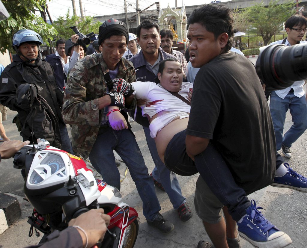 epa04050488 A injured Thai pro-government supporter who has been shot is carried to hospital during clashes with anti-government protesters who were blocking the Lak Si district office to seized ballot boxes and prevent it from being used as a polling station in Bangkok, Thailand, 01 February 2014. Gunshots were fired during a confrontation between Thai government supporters and anti-government protesters, injuring at least three people. Thailand's snap election on 02 February is due to proceed despite rising political tensions and concerns related to possible violence and polls facing difficulties. Anti-government protesters vowed to 'completely shutdown' the capital on elections day. The decision to call a snap election came about after Thai Prime Minister Yingluck dissolved the parliament on 09 December 2013. The main opposition Democrat Party has boycotted the polls.  EPA/PONGMANAT TASIRI