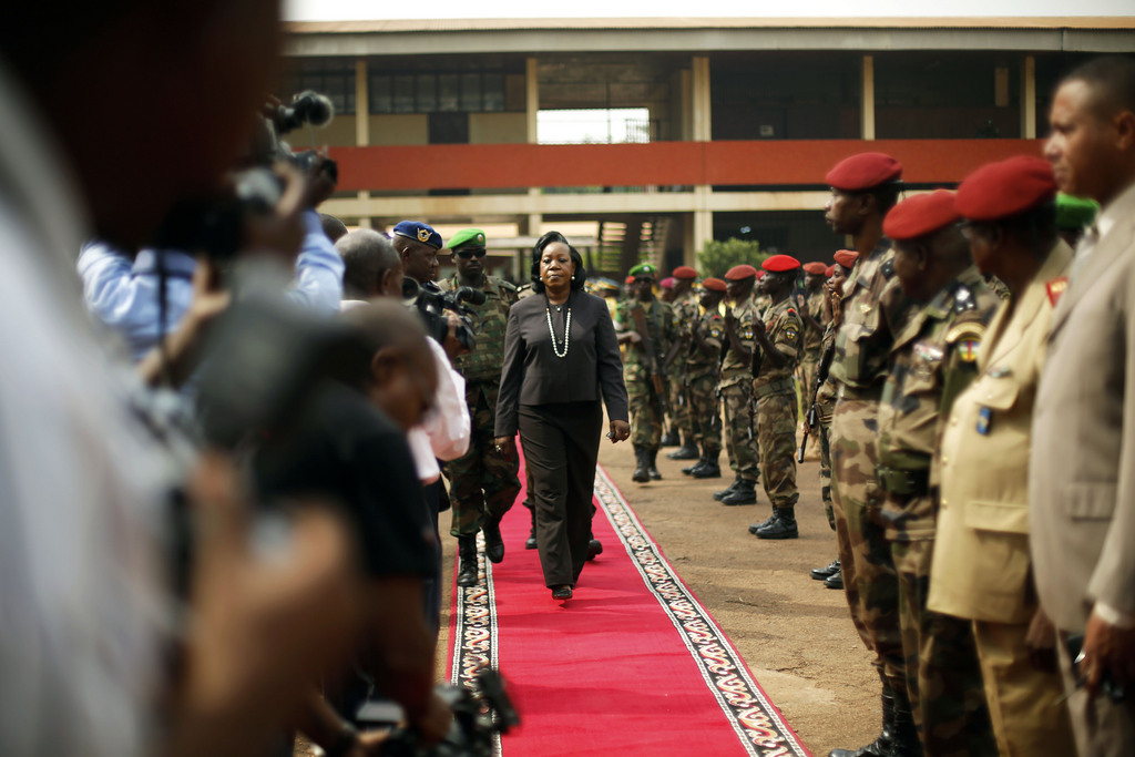 Central African Republic Interim President Catherine Samba-Panza walks the red carpet after addressing newly enlisted FACA (Central African Armed Forces) soldiers in Bangui, Wednesday Feb. 5, 2014. Moments later, the soldiers lynched and killed a suspected Muslim Seleka militiaman in front of African Union troops who made no effort to stop the killing. (AP Photo/Jerome Delay)