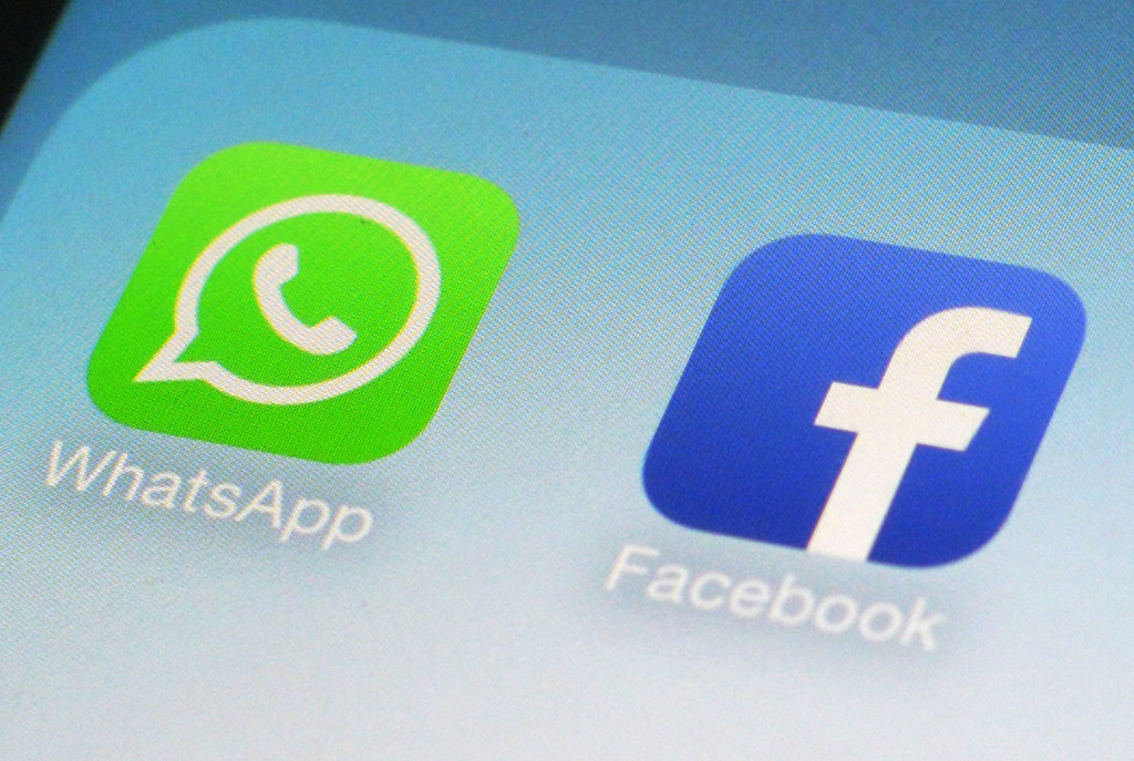 This Wednesday, Feb. 19, 2014 photo shows the WhatsApp and Facebook app icons on an iPhone in New York. On Wednesday, the world's biggest social networking company announced it is buying mobile messaging service WhatsApp for up to $19 billion in cash and stock. (AP Photo/Patrick Sison)