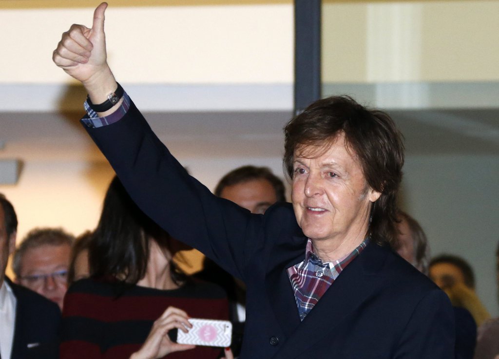 epa04091778 British musician Paul McCartney greets as he eaves the exhibition 'Linda McCartney retrospective 1965-1997', in Montpellier, southern France, 20 February 2014.  EPA/GUILLAUME HORCAJUELO