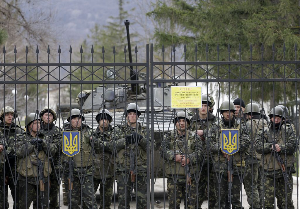 Des soldats ukrainiens gardent l'entrée d'une base d'infanterie à Privolnoye.