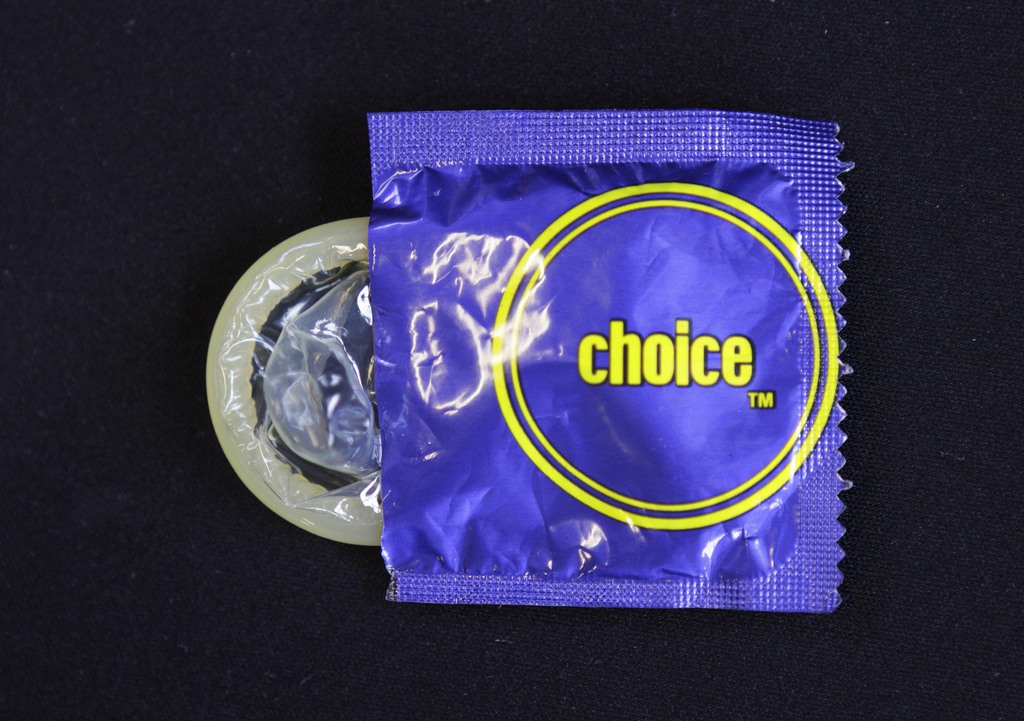 A condom, similar to those distributed at the African National Congress party's centenary celebrations early January, is photographed in Johannesburg Tuesday, Jan. 31, 2012. A South African health official says that 1.35 million of the condoms are being recalled amid charges some broke during intercourse and were porous. (AP Photo/Denis Farrell)