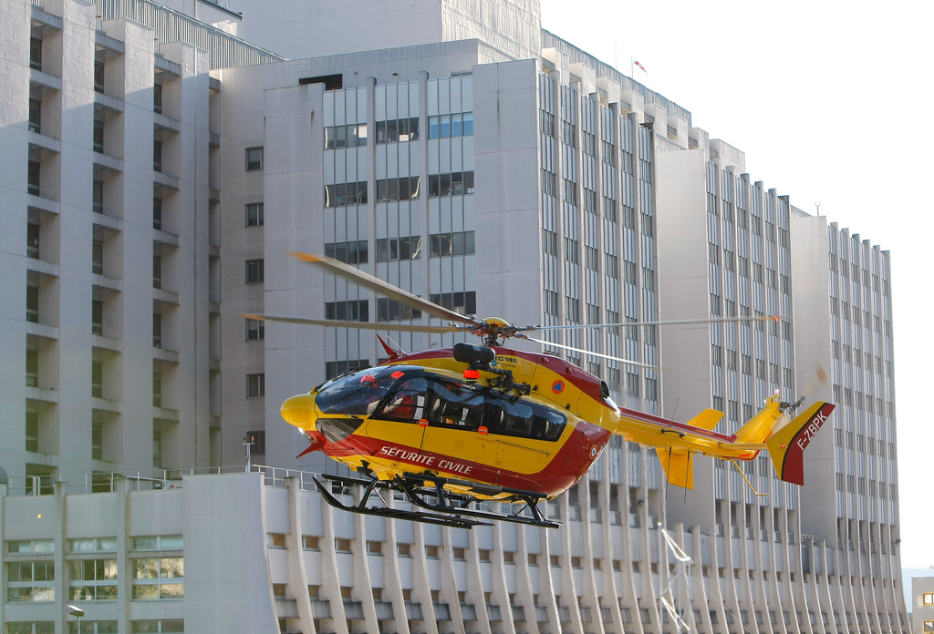 A Civil Security helicopter takes off  in front of the Grenoble hospital, French Alps, Sunday, Jan. 5 , 2014, where former seven-time Formula One champion Michael Schumacher is being treated after sustaining a head injury during a ski accident. Schumacher has been in a medically induced coma since Sunday, Dec. 29, 2013, when he struck his head on a rock while on a family vacation. (AP Photo/Claude Paris)