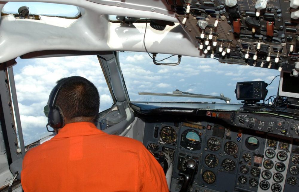 epa04121131 A handout photo released by the Indonesian Airforce on 12 March 2014 shows an airforce pilot during a search mission for a Malaysian Airlines aircraft on board of a military surveillance airplane over the Malacca straits, 11 March 2014. The search for missing Malaysia Airlines flight MH370 was expanded, including more areas that were not on its flight path. Nearly 100 vessels and aircraft from 10 countries in Asia and the Pacific, including Malaysia, were scouring the South China Sea to locate the Boeing 777-200 that disappeared on en route to Beijing from Kuala Lumpur on 08 March.  EPA/INDONESIAN AIRFORCE / HANDOUT  HANDOUT EDITORIAL USE ONLY/NO SALES