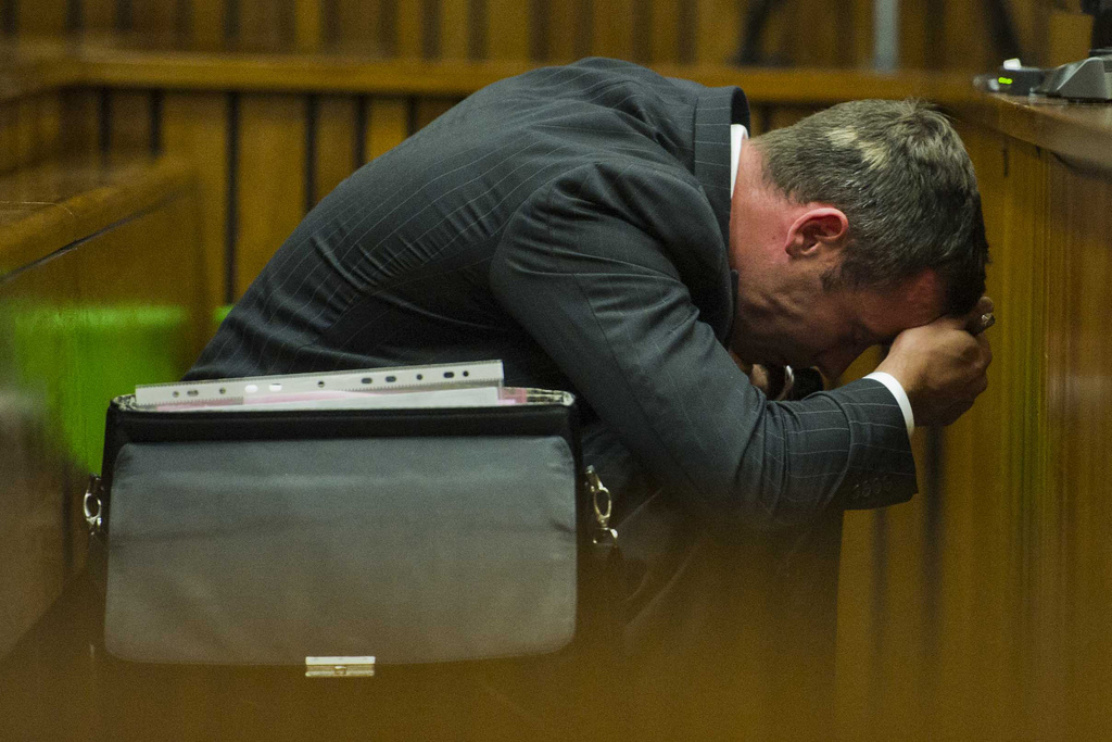 Oscar Pistorius puts his hands to his head as he listens to forensic evidence during his trial in court in Pretoria, South Africa, Thursday March 13, 2014. Pistorius is charged with the shooting death of his girlfriend Reeva Steenkamp on Valentines Day in 2013. (AP Photo/Alet Pretorius, Pool)