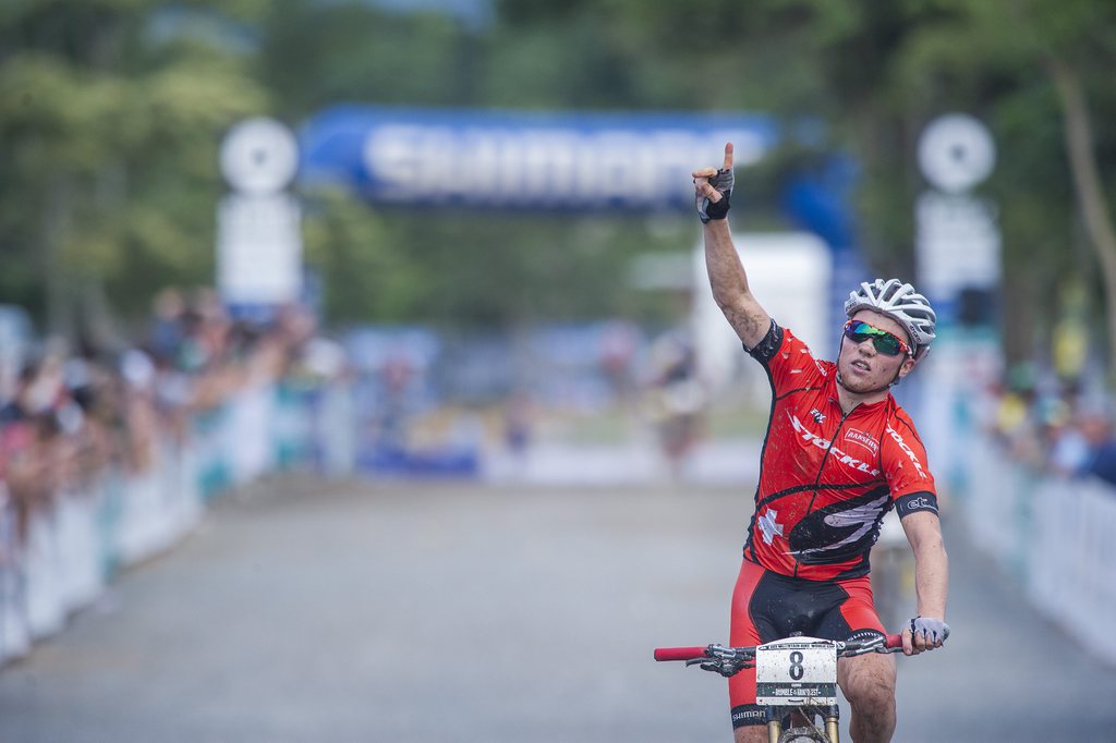 epa04181944 Switzerland's Mathias Flueckiger salutes as he finished second in the Elite Men's  Olympic Cross-country event at the Mountain Bike World Cup in the Smithfield Regional Park, Cairns, Australia, 27 April 2014.  EPA/BRIAN CASSEY AUSTRALIA AND NEW ZEALAND OUT