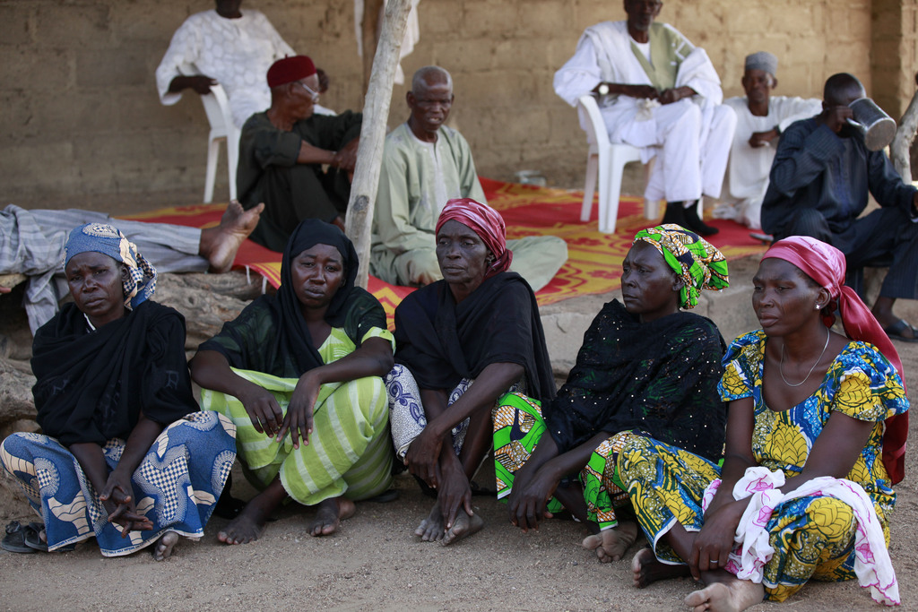 In this photo taken Sunday, May 18, 2014, some of the mothers of the kidnapped school girls sit in Chibok, Nigeria. More than 200 schoolgirls were kidnapped from a school in Chibok in Nigeria's north-eastern state of Borno on April 14. Boko Haram claimed responsibility for the act. (AP Photo/Sunday Alamba)