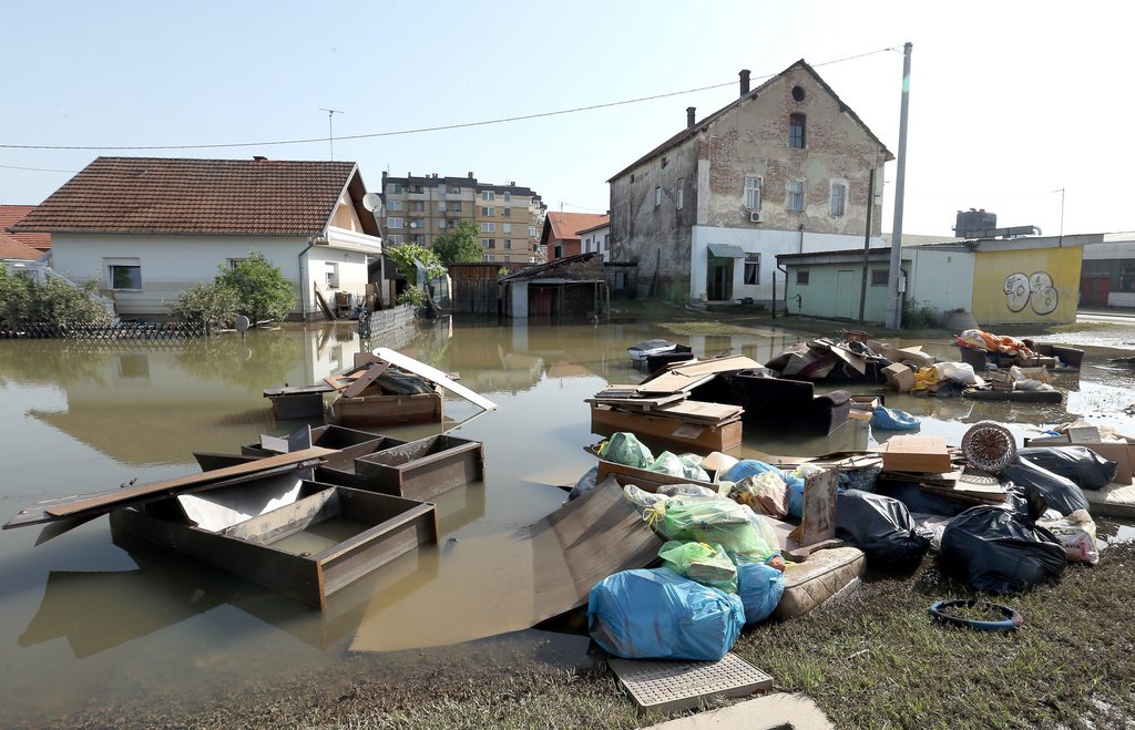 epa04220469 Flood damaged furniture, matresses and household effects are left on the streets after flood waters slowly recedes from the town of Bosanski Samac, in the northern part of Bosnia and Herzegovina, some 250 kilometers from the Bosnian capital Sarajevo, 23 May 2014. As the waters from the worst flooding the Balkans has seen in more than a century subside and the destruction is assessed, the threat of disease is now one of the biggest concerns for authorities. Left behind are cadavers and plumbing, along with stagnant puddles and lots of mud, all of which could be infested with dangerous parasites and bacteria.  EPA/FEHIM DEMIR