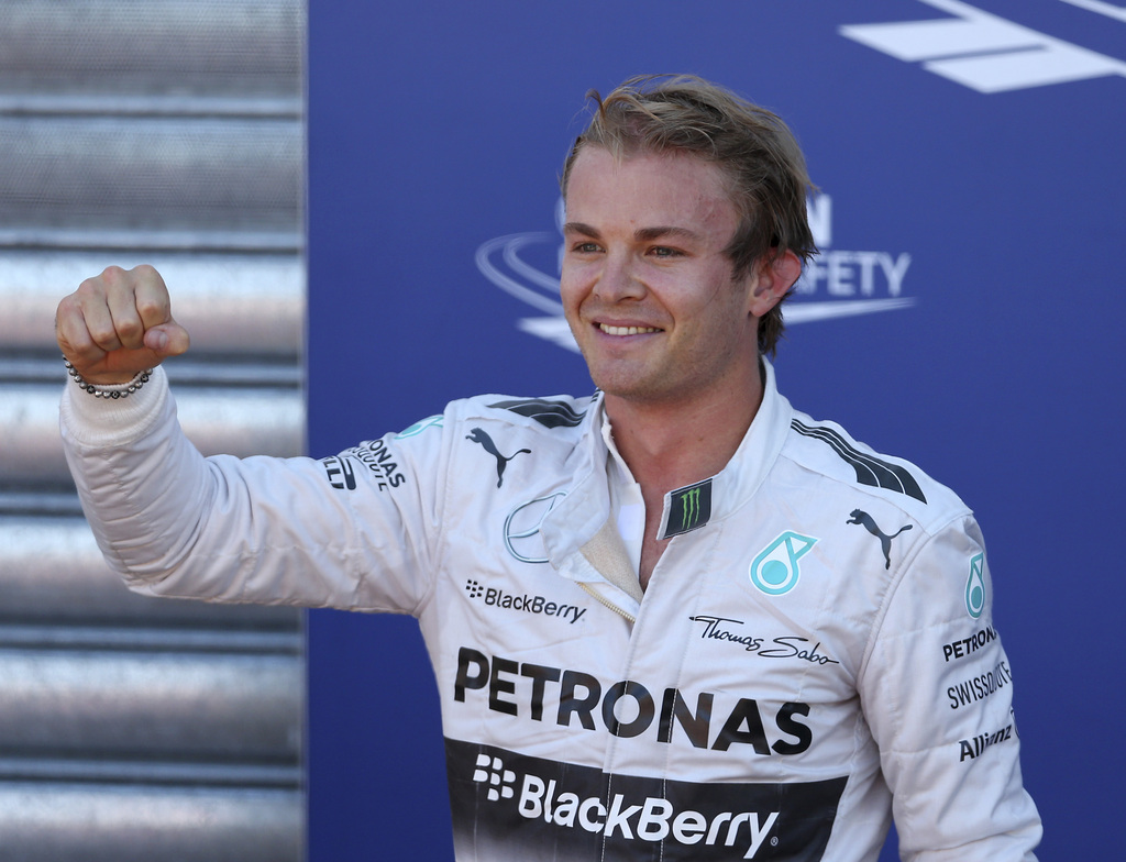 Mercedes driver Nico Rosberg, of Germany, celebrates after setting the pole position in the qualifying session at the Monaco racetrack, in Monaco, Saturday, May 24, 2014. The Monaco Formula One Grand Prix will be held on Sunday. (AP Photo/Antonio Calanni)