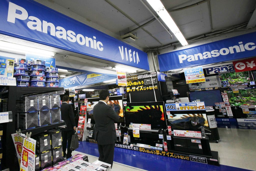 In this Thursday, May 9, 2012 photo,  Shoppers look at Panasonic products at an electronics store in Tokyo. Japanese consumer electronics giant Panasonic Corp. on Friday reported a near-record net loss of 754 billion yen ($7.5 billion) for the fiscal year through March due to restructuring costs and slumping sales, but predicted a return to the black this year as it prunes unprofitable businesses. (AP Photo/Koji Sasahara)