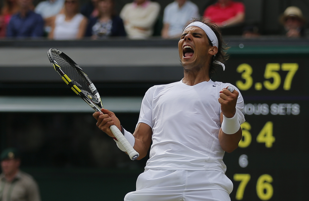 Rafael Nadal of Spain celebrates as he defeated Lukas Rosol of Czech Republic  in their men's singles match on Centre Court at the All England Lawn Tennis Championships in Wimbledon, London, Thursday, June 26, 2014. (AP Photo/Pavel Golovkin)