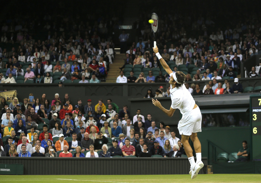 Roger Federer of Switzerland serves to Gilles Muller of Luxembourg during their men's singles match at the All England Lawn Tennis Championships in Wimbledon, London, Thursday, June 26, 2014. (AP Photo/Sang Tan)