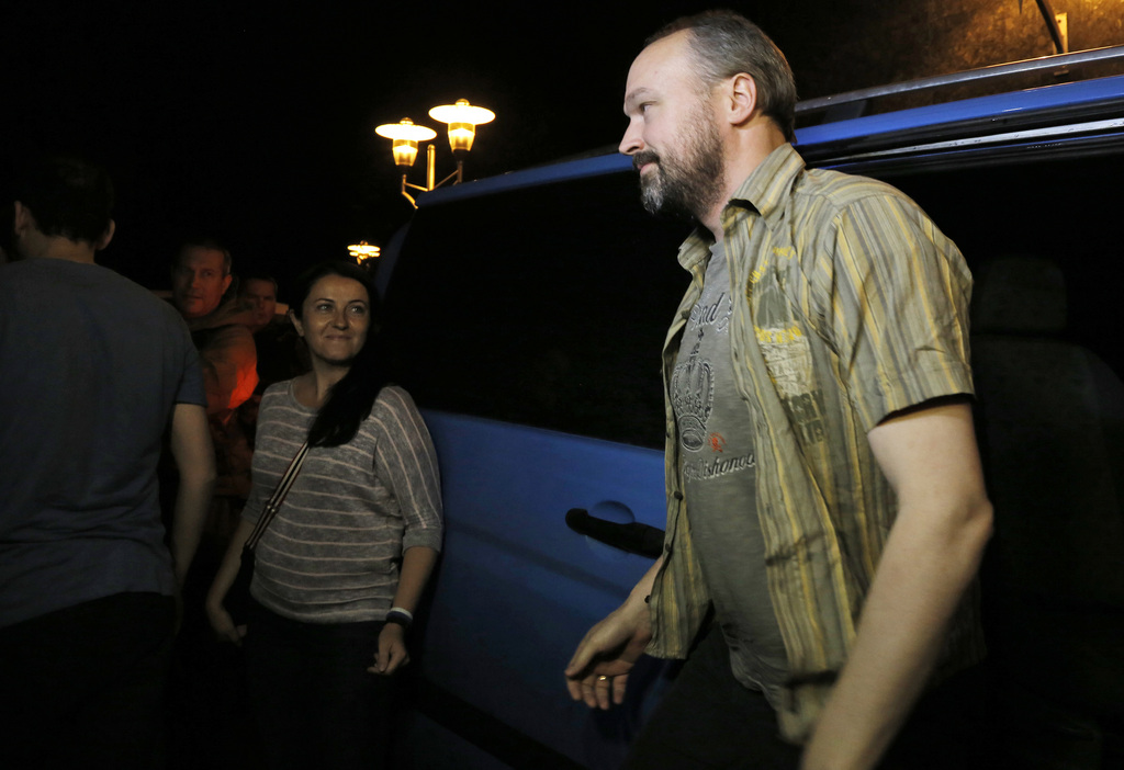 An unidentified member of the OSCE Special Monitoring Mission in Ukraine gets out of a vehicle in the city of Donetsk, Ukraine, early Friday, June 27, 2014. Four members of the mission were released by officials of the self proclaimed Donetsk People's Republic after one month captivity. (AP Photo/Dmitry Lovetsky)