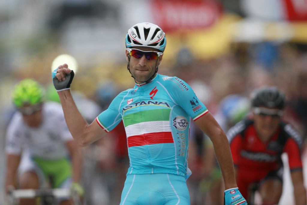 Italy's Vincenzo Nibali crosses the finish line ahead of Peter Sagan of Slovakia, left, and Belgium's Greg van Avermaet to win the second stage of the Tour de France cycling race over 201 kilometers (124.9 miles) with start in York and finish in Sheffield, England, Sunday, July 6, 2014. (AP Photo/Peter Dejong)